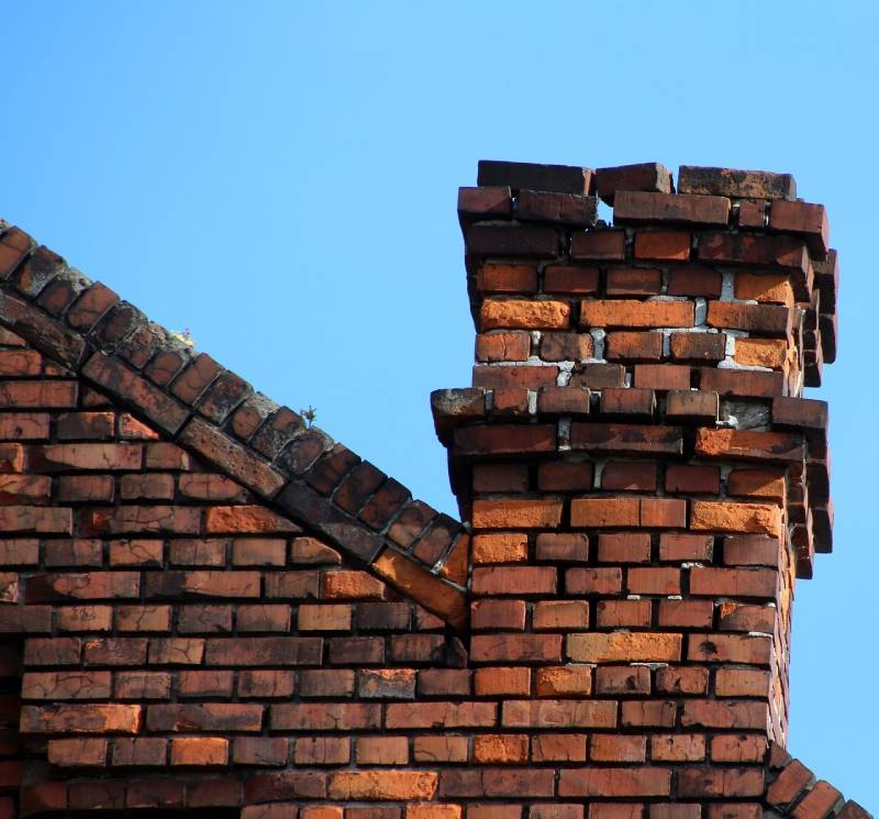 Damaged chimney on an Sachse home showing cracks and missing mortar